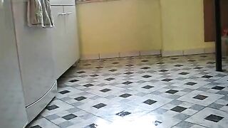 Latex-clad brunette maid's solo kitchen play.