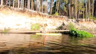 Tattooed Babe Strips and Swims on a SUP Board in the Forest River