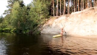 Tattooed Babe Strips and Swims on a SUP Board in the Forest River