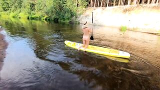 Tattooed Babe Strips and Swims on a SUP Board in the Forest River