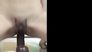 Asian Girl Rides a Huge Black Dildo