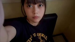 A female college student masturbates alone in a private room at a karaoke bar, using a technique she has just learned.