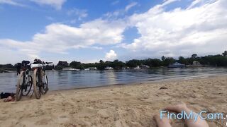 Solo brunette pleasures herself on a public beach.