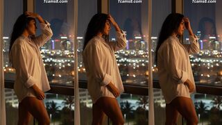 Transgirl in White Shirt Poses by City Window